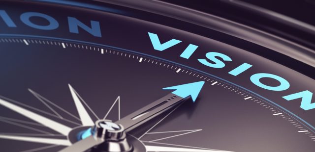 Compass with needle pointing the word vision with blur effect plus blue and black tones. Conceptual image for immustration of company or business anticipation or strategy